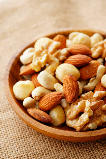 istock Mixed nuts in a wooden plate. 1134040823