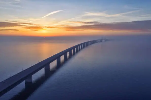 Stunning sunset over the Oresundsbron Oresund bridge between Sweden and Denmark, from Malmö shore. High aerial photograph with drone.