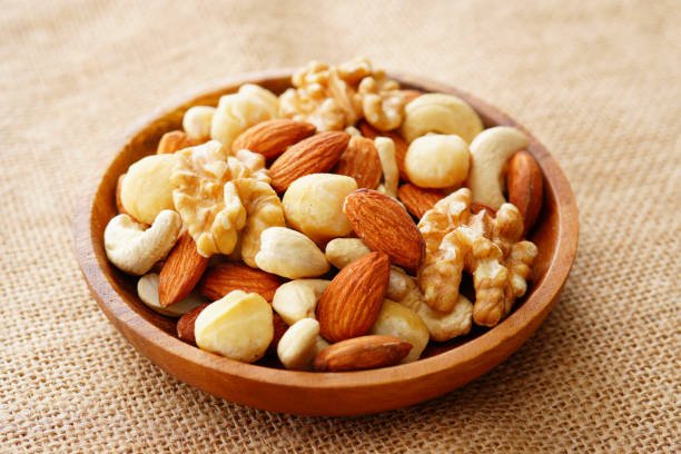 istock Mixed nuts in a wooden plate. 1134041106