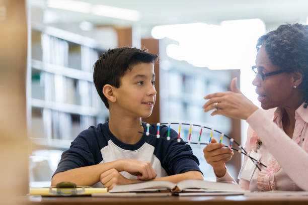 istock Middle school age boy receives help with science homework 1134043504