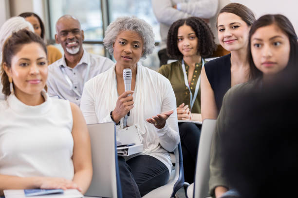 istock Mature businesswoman asks question during seminar 1134043638