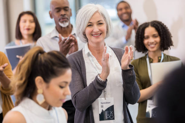 istock Confident business woman applauds during conference 1134043641
