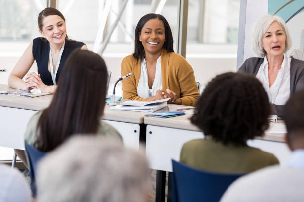 istock Confident women sit on panel during women's conference 1134043649