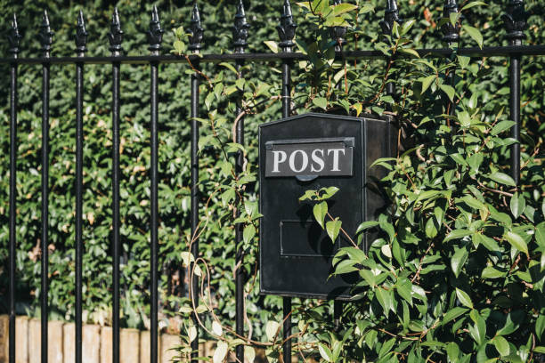 istock Close up of a black post box on a fence. 1134044608