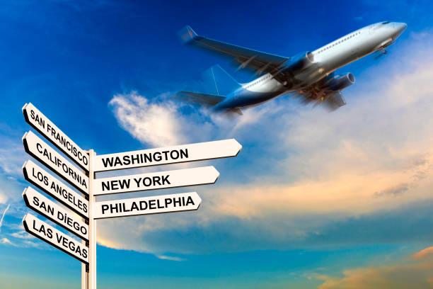 istock Signpost, departing passenger plane and cloud landscape at sunset 1134044811