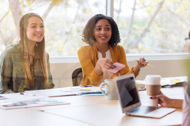 istock Cheerful design professionals enjoy brainstorming session 1134044987