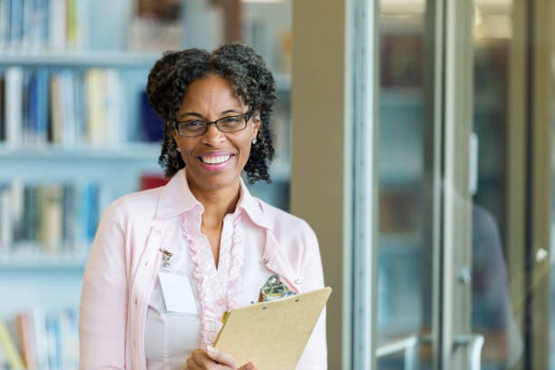 istock Portrait of friendly school librarian 1134045021