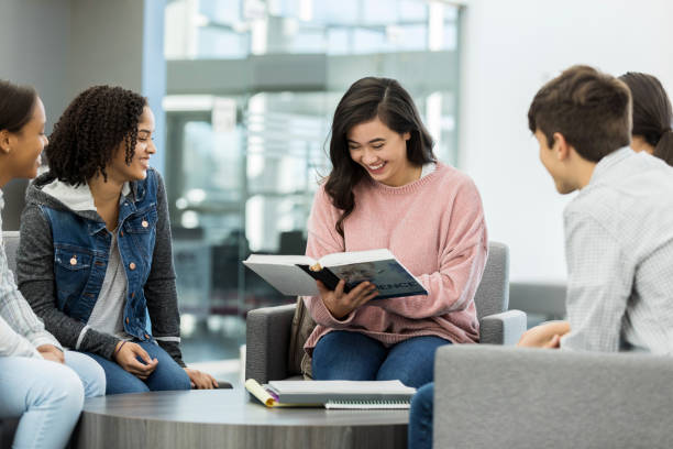 istock Cheerful girl reads aloud from textbook 1134045072