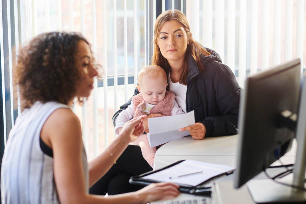 young mother with support worker young mother with social services or housing officer social services stock pictures, royalty-free photos & images