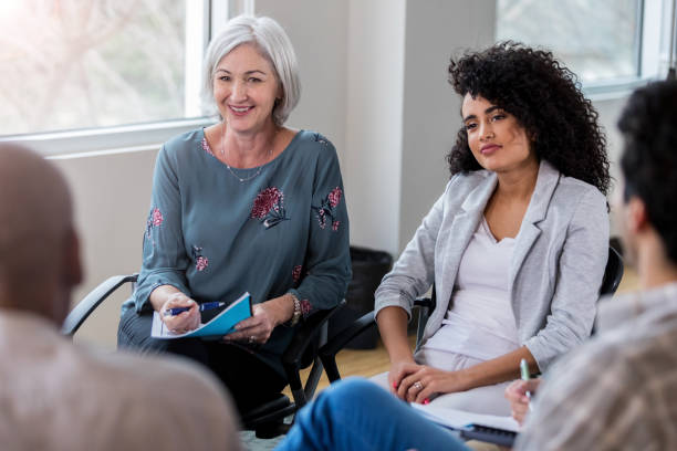 istock Caring therapist facilitates group therapy meeting 1134045196