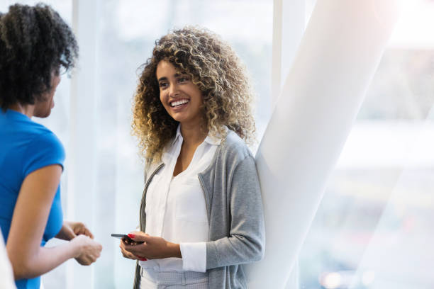 istock Happy businesswomen chat in office skybridge 1134045269