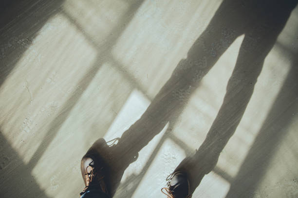 Standing On The Floor In The Light Through Window Standing On The Floor In The Light Through Window 靴 stock pictures, royalty-free photos & images
