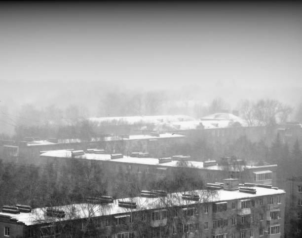 istock Zigzag roofs of buildings during snowing background 1134046969