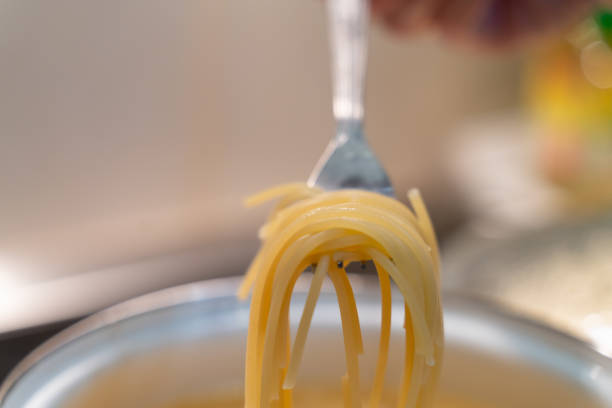 istock abstract spaghetti background in boiling broth on fork close up. 1134046990
