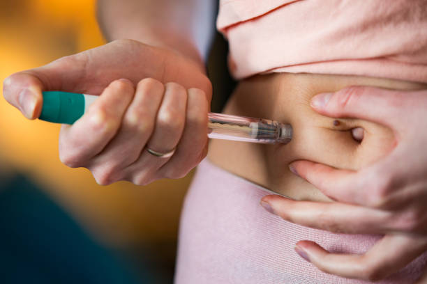 mujer que hace la inyección con la pluma de jeringa - diabetes insulin human fertility injecting fotografías e imágenes de stock