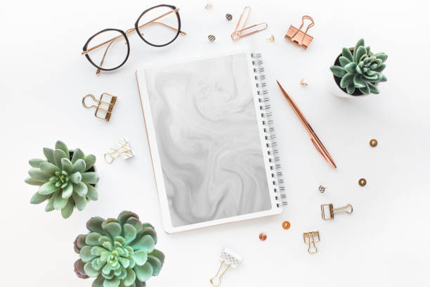 istock Elegant work table with business accessories on withe background.luxury feminism style 1134051325