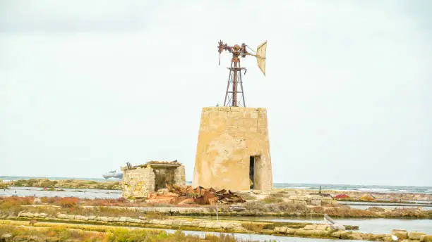 An old windvane on the a small tower in Trapani Sicily found in the middle of the saltmine field  in Italy