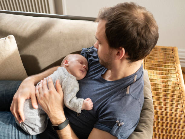 istock Young father happily holding newborn son 1134054709