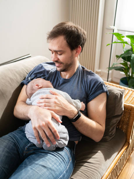 istock Young father happily holding newborn son 1134054718