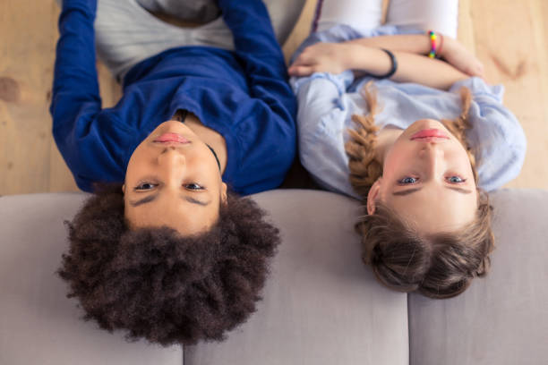 istock Frustrated schoolchildren leaning their heads on sofa 1134058264