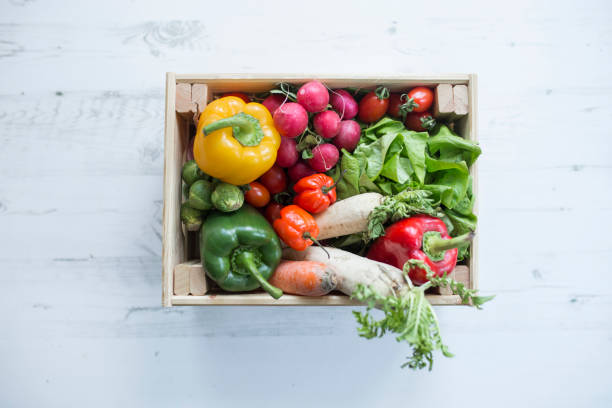 istock Veggies in wood box with white wood backdrop 1134063870