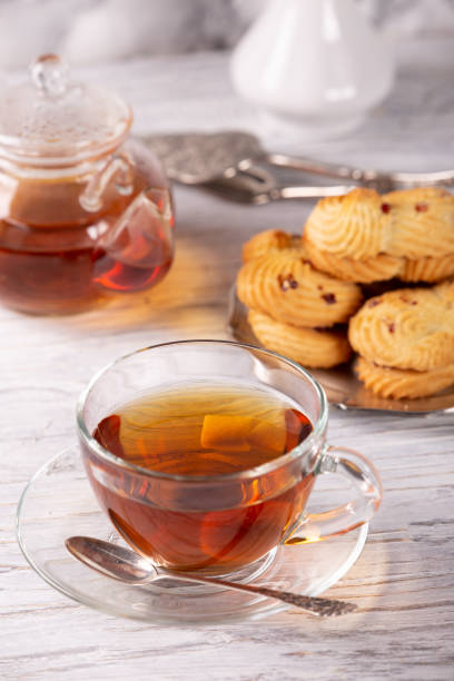 istock transparent teapot and cup of hot tea 1134064586