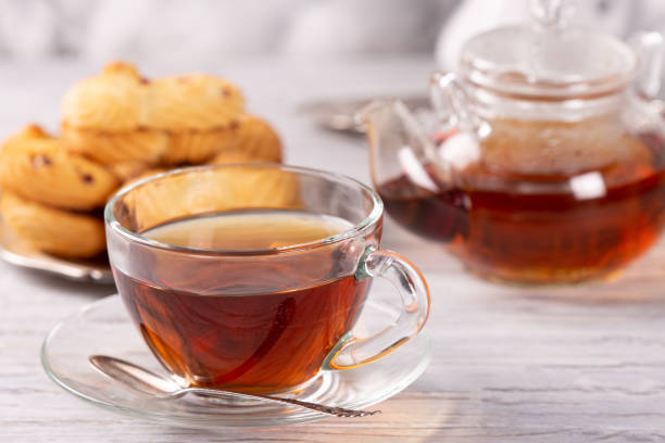 istock transparent teapot and cup of hot tea 1134064624