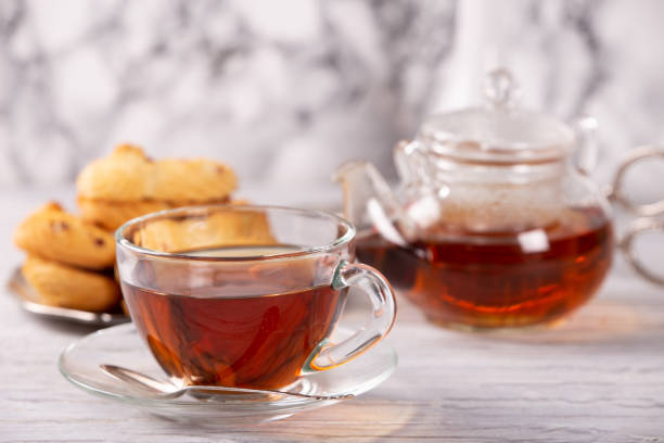 istock transparent teapot and cup of hot tea 1134064656