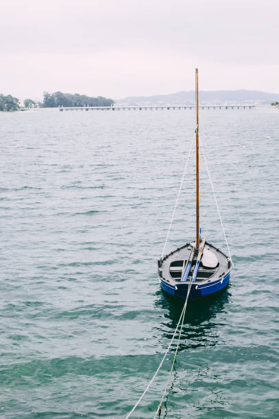 Horizontal view of sailing boat masts against sky background