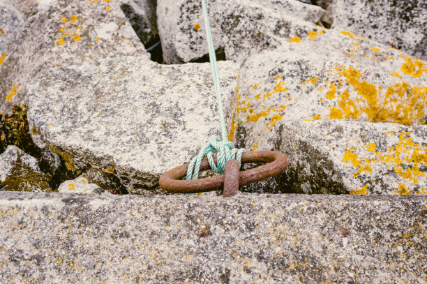 Chain anchor to beech to hold fishing vessels pulled up high on the shingle beach at Aldburgh in Suffolk England