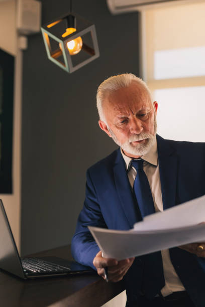 istock Senior businessman analysing documentation 1134065354