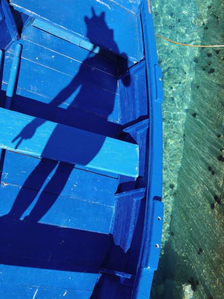 istock Unicorn shadow on a boat / turquoise colored water 1134065930