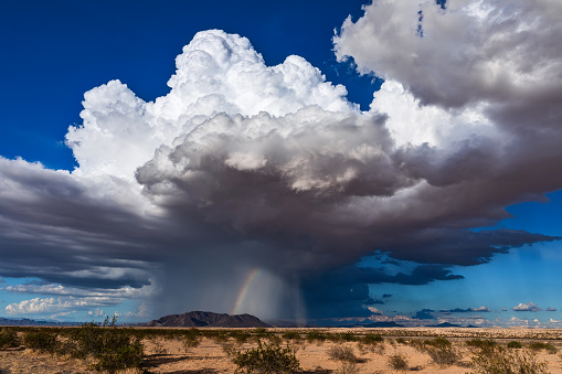 Cumulonimbus thunderstorm cloud with heavy rain and a landspout tornado in the desert near Parker, Arizona.