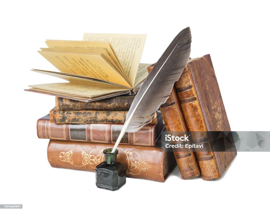 Old books and a quill Pile of the old books and a quill in the inkwell isolated on a white background Cut Out Stock Photo