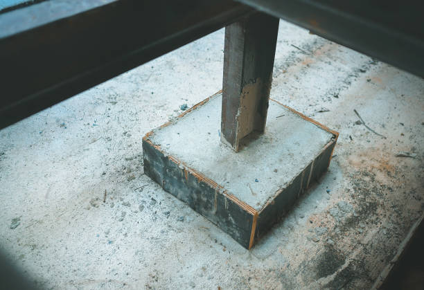 Metal poles on concrete bases. Foundation construction site making reinforcement metal framework for pouring concrete to home building.