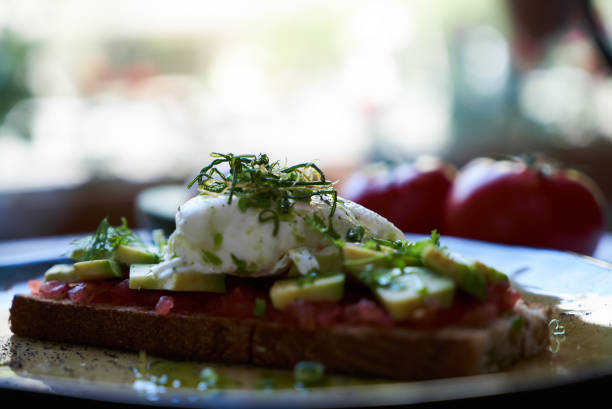 istock Avocado Toast and Poached Egg with Baked Tomatoes, close-up 1134074006
