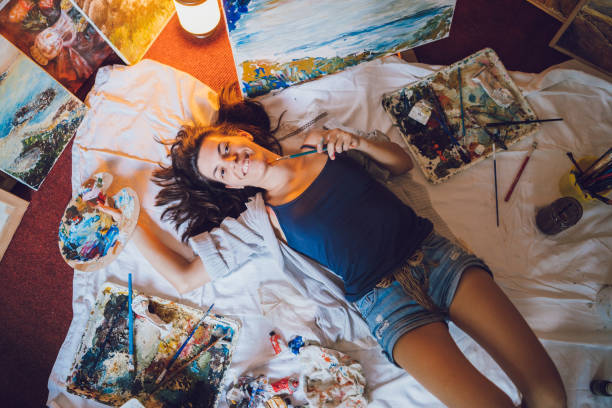 istock Woman painter surrounded with her art 1134074342