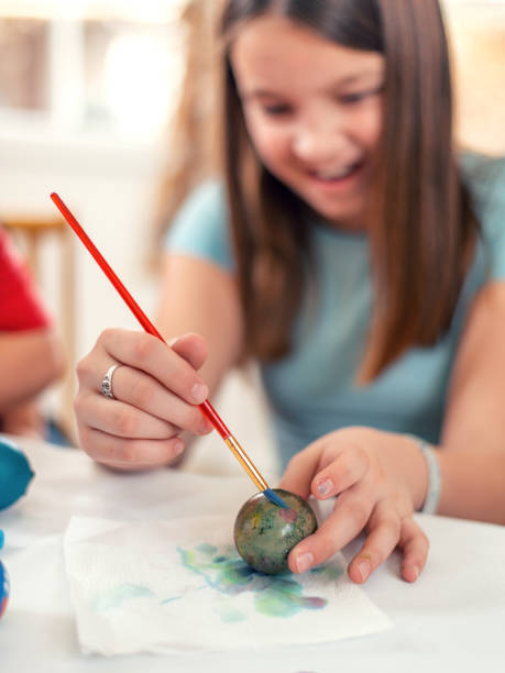 istock Little girl painting easter eggs 1134075926