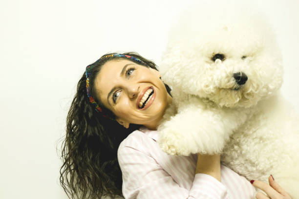 istock Woman with her dog over white background 1134076681