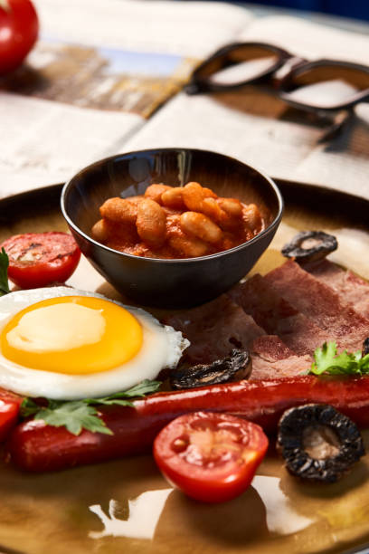 istock Full English breakfast with bacon, sausage, fried egg, baked beans 1134077471
