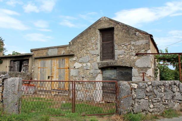 istock Traditional stone house abandoned by owners with doors and windows closed with improvised doors made of wooden boards 1134078255