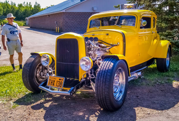 Chascomús, Argentina - Apr 15, 2023: Old yellow 1950s Ford F 1 V8 pickup truck on the lawn at a classic car show in a park.