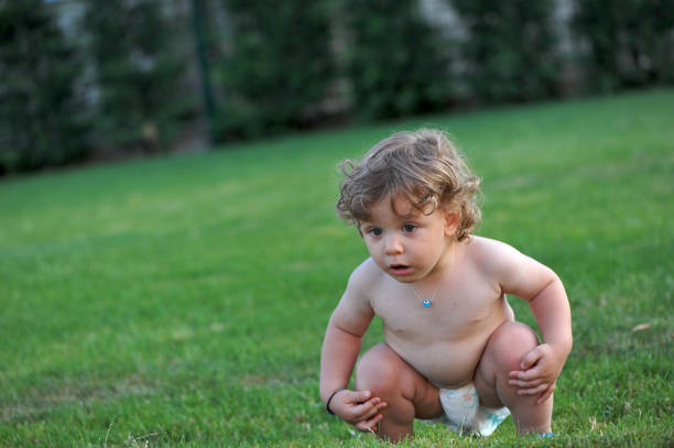 istock Baby wearing diaper, playing with water 1134079577