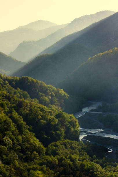 istock Sunset at Caucasus mountains in summer. Green valley with river. Tonal perspective composition. Beautiful nature concept 1134079865