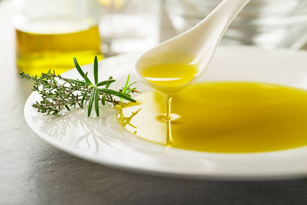 Olive oil with herbs stock photo