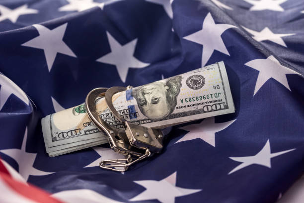 istock American dollars in handcuffs on national flag 1134081330