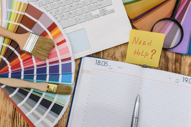 istock Color swatches with diary, laptop and 'need help' text 1134081572