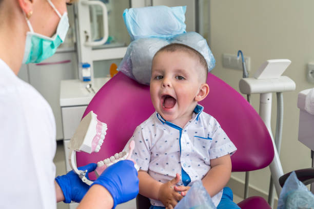 Little boy showing his teeth to a doctor stock photo