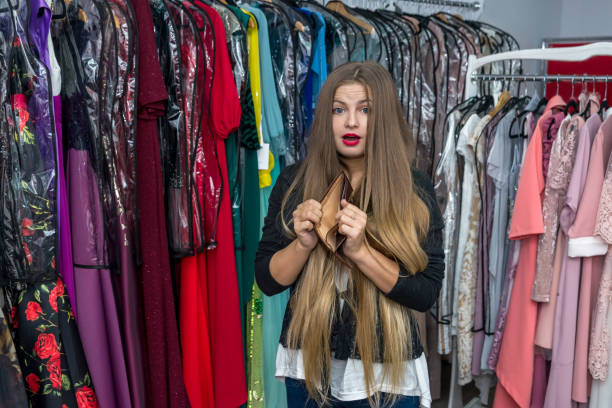 istock Woman with empty wallet in dress store 1134082551