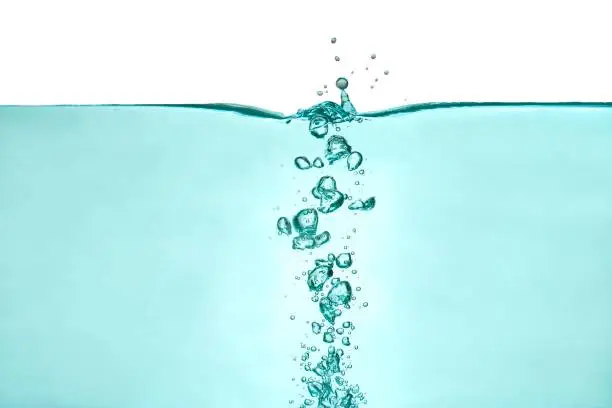 Column of air bubbles in the water, water splashes